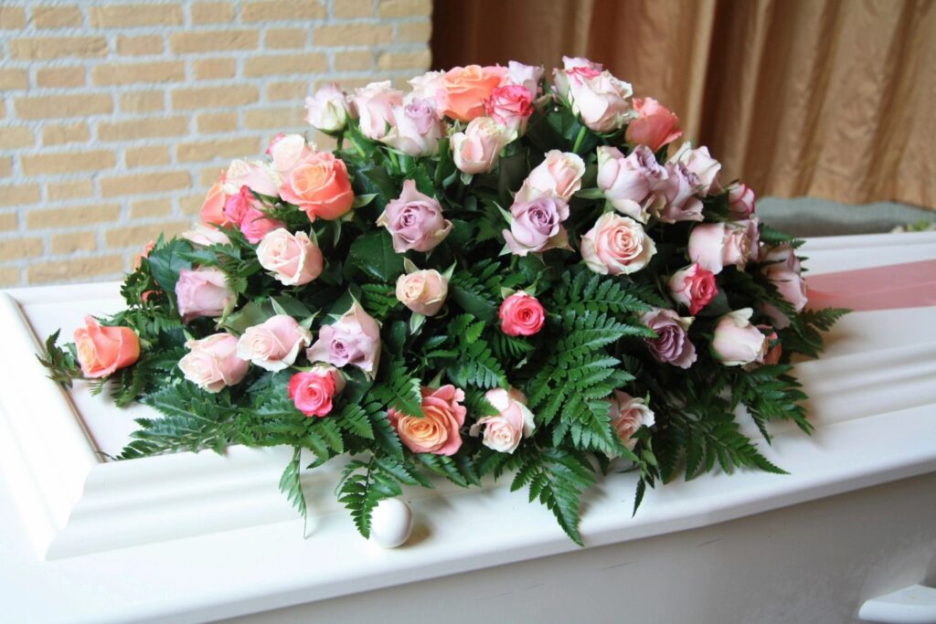 Pink and white roses on a casket.