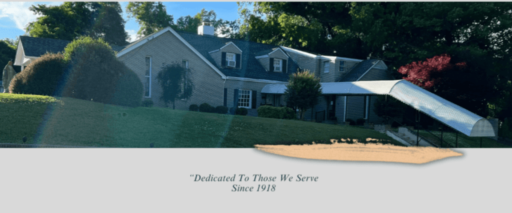 Large house with tree-lined yard, text below.